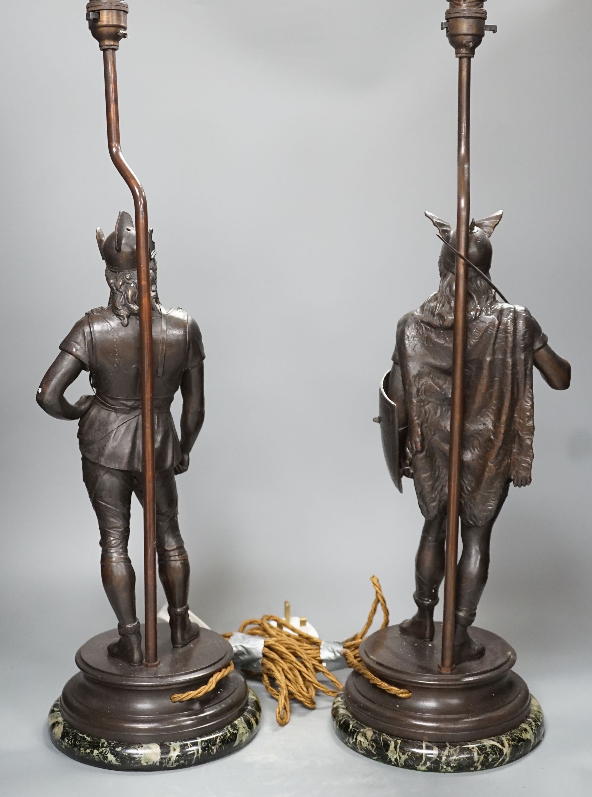 A pair of spelter warrior lamps on marbled plinth base - 62cm high